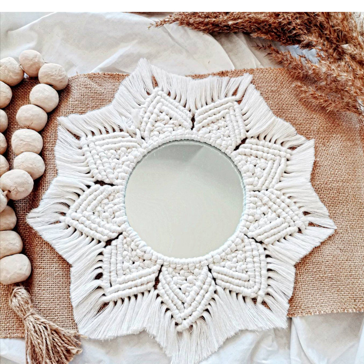 White hand-knotted macrame wall mirror with floral motif