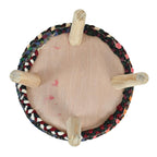 Multi color jute ottoman chair used as a footrest