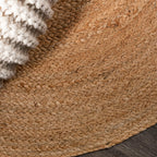 Natural round jute rug from above — handwoven India