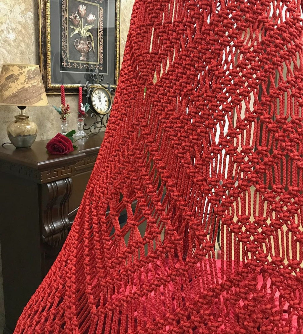 Handmade red macrame swing for living room
