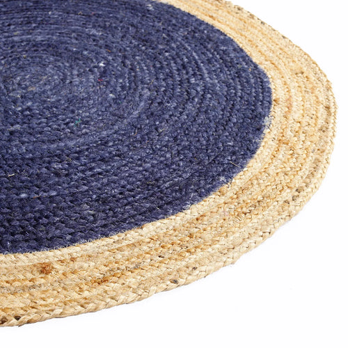 Blue braided round jute rug side view — handwoven natural fibre