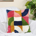 Geometric patchwork hand-tufted cushion cover styled on a sofa