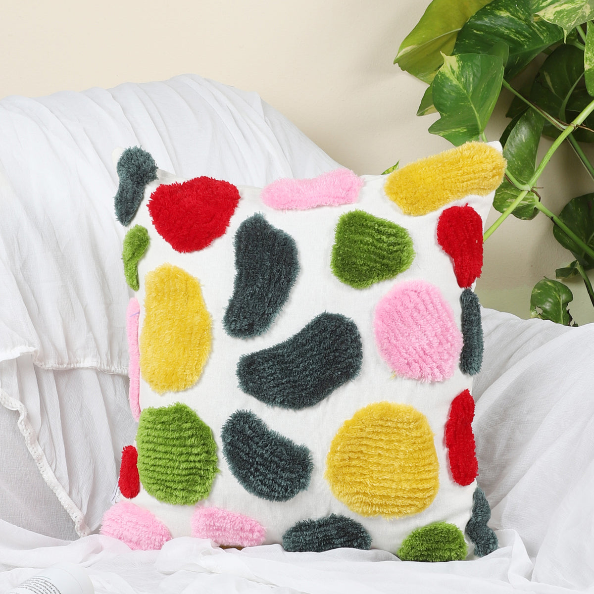 Abstract spotted hand-tufted cushion cover styled on a sofa