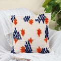 Abstract tasseled hand-tufted cushion cover styled on a sofa