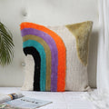 Rainbow tufted cushion cover styled on a sofa