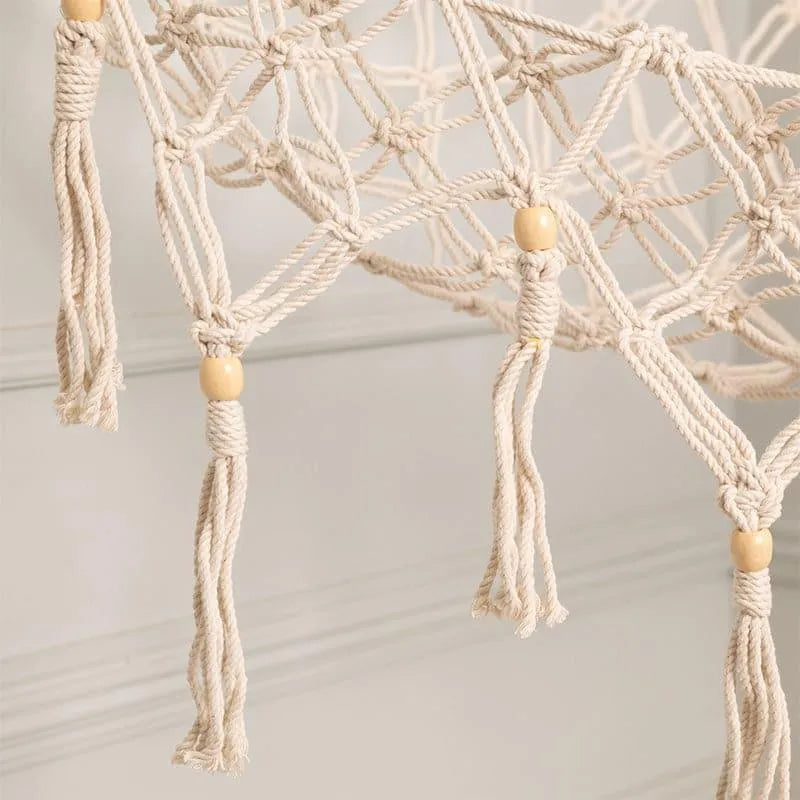 White macrame toy hammock holding plush toys