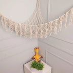 White macrame toy hammock string light detail