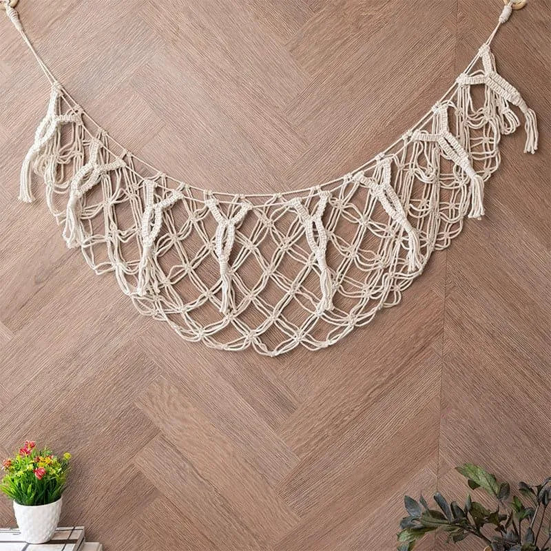 Soft white macrame toy hammock holding plush toys