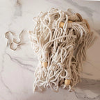 White macrame toy hammock wooden bead detail